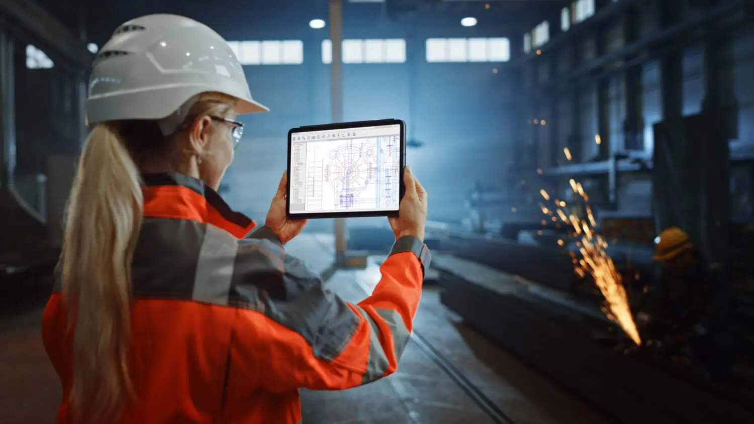 Person on iPad in factory
