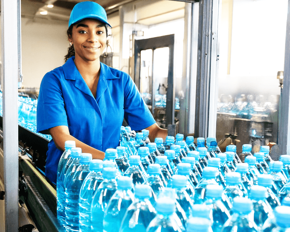 female driver picking up bottles at a production facility